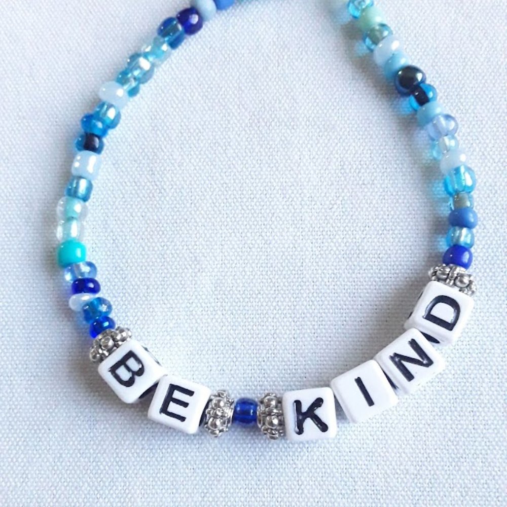 Handmade Bracelet with Be Kind in Large square letters and Various blue beads